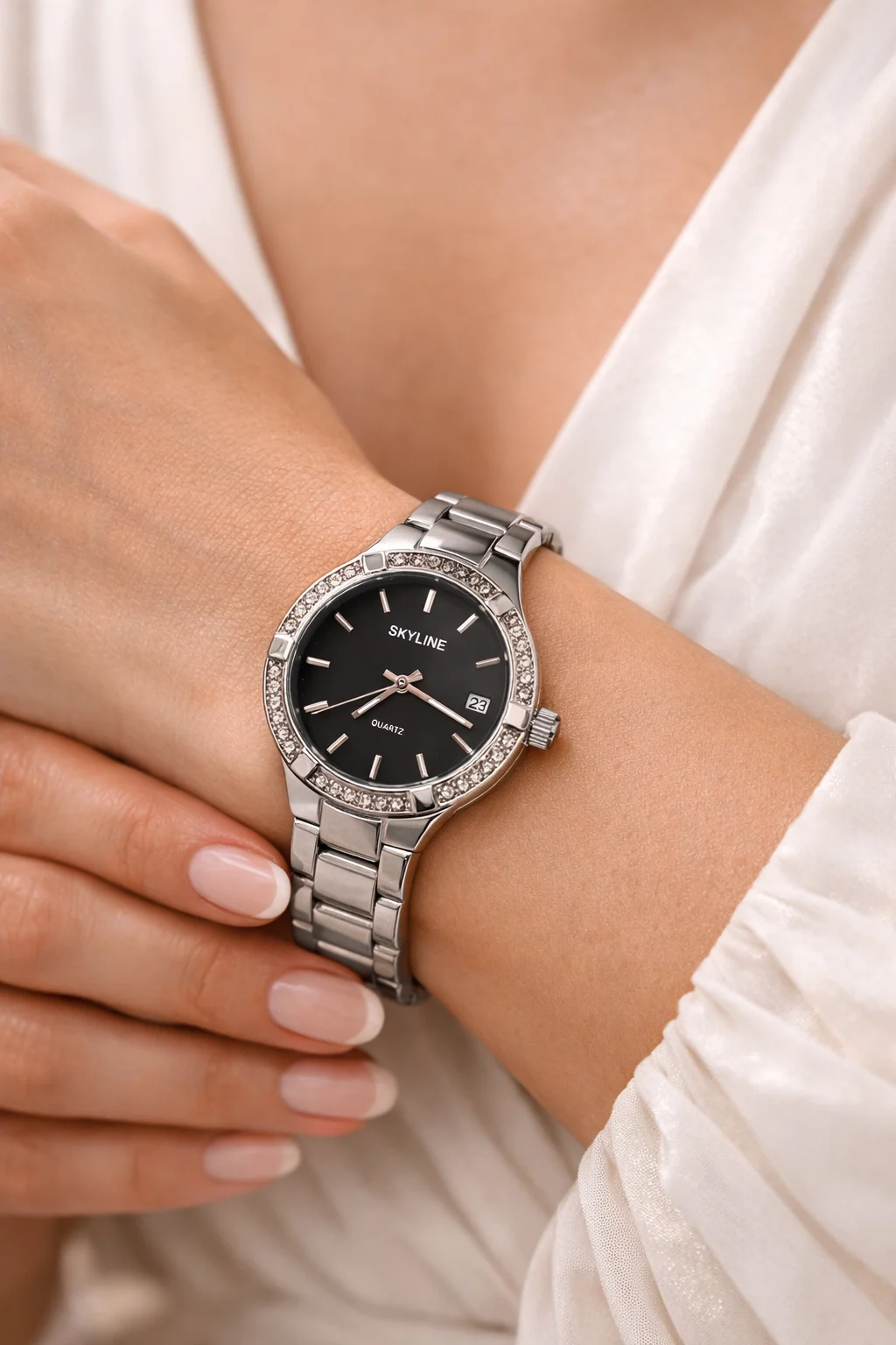 Reloj Skyline Éclipse Steel en la muñeca de una mujer con vestido blanco